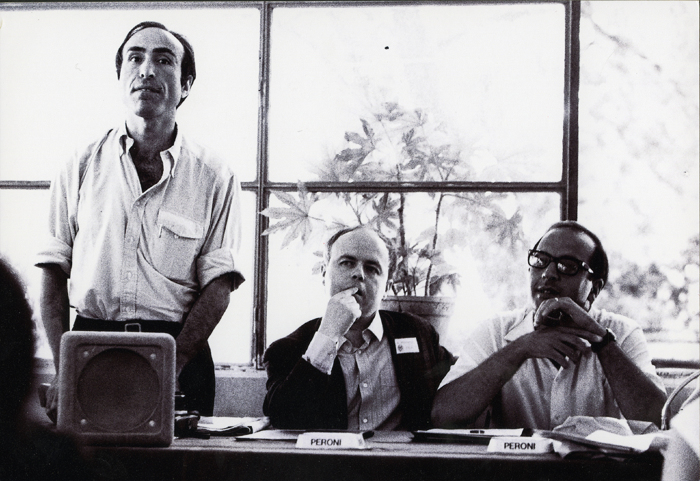 Mauro Mancia in piedi a sinistra insieme a Elvio Fachinelli e ad altri partecipanti al convegno (© Lisetta Carmi 1969, Collezione privata)